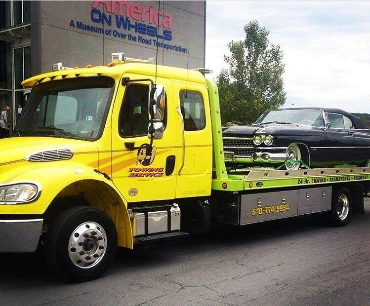 America on Wheels Transport low boy truck delivering a car on the back